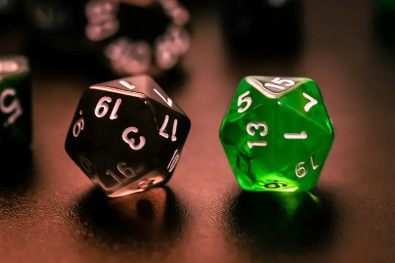 green and black dice on brown wooden table